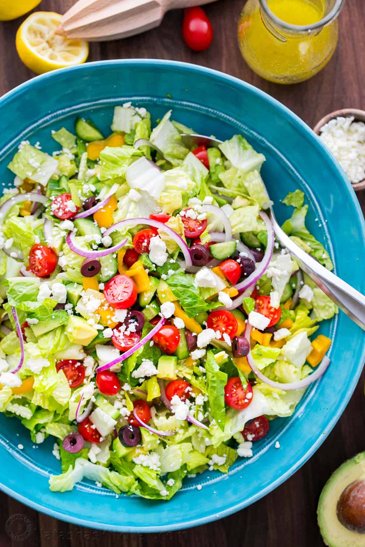 Tossed Chopped Greek salad with serving spoon