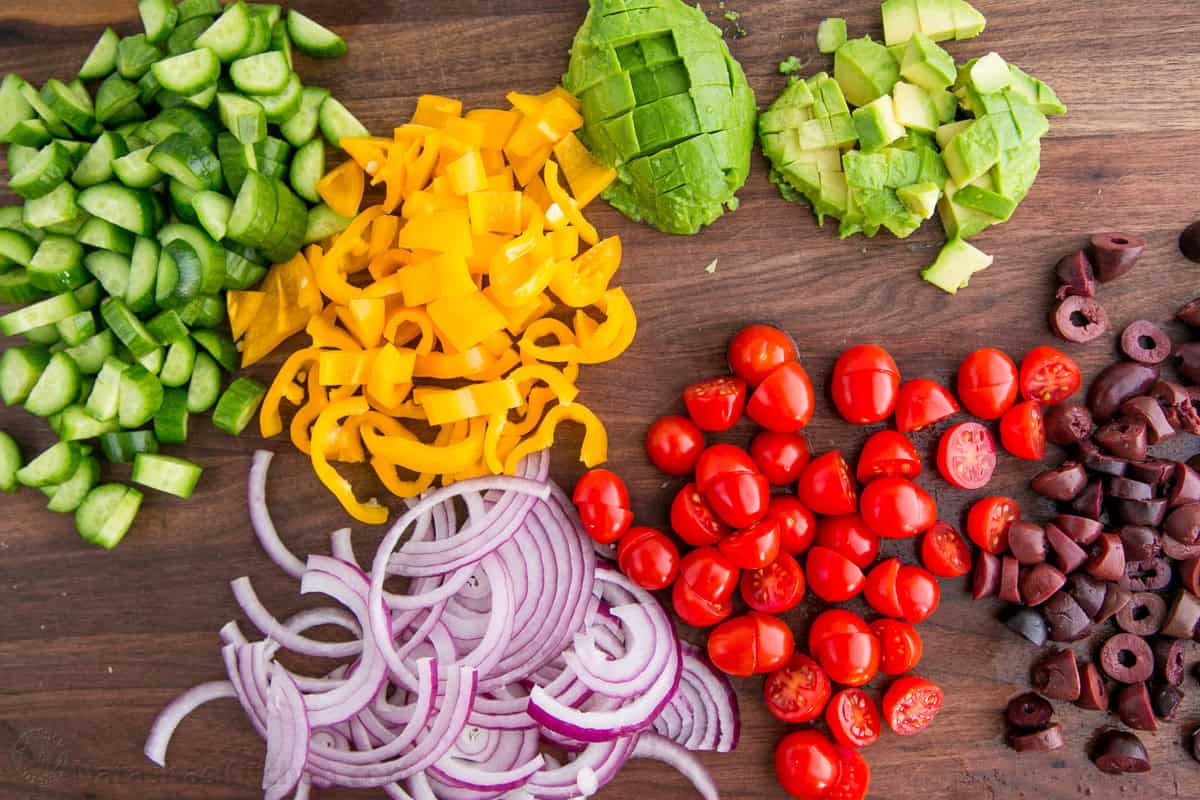 Ingredients sliced and prepped for chopped greek salad