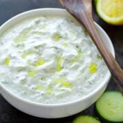 Tzatziki sauce in a bowl drizzled with olive oil