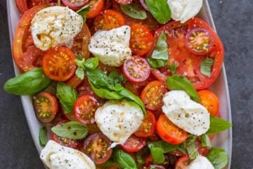 Burrata Salad with tomatoes on platter