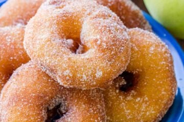 Apple fritters coated in cinnamon sugar served on plate