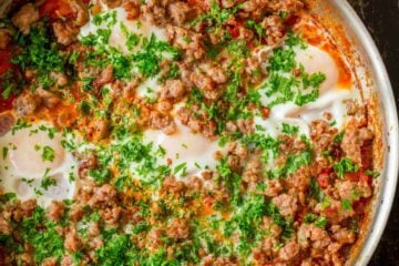 Shakshuka served in skillet with toasts