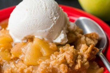 Apple crisp served on plate with ice cream