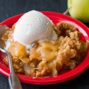 Apple Crisp served on a red plate with ice cream
