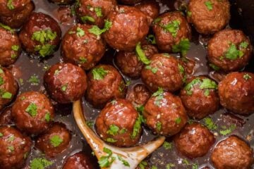 Grape jelly Meatballs in slow cooker with serving spoon