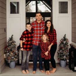 Family smiling at front door