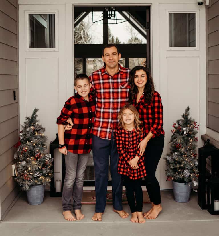 Family smiling at front door