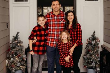 Family smiling at front door