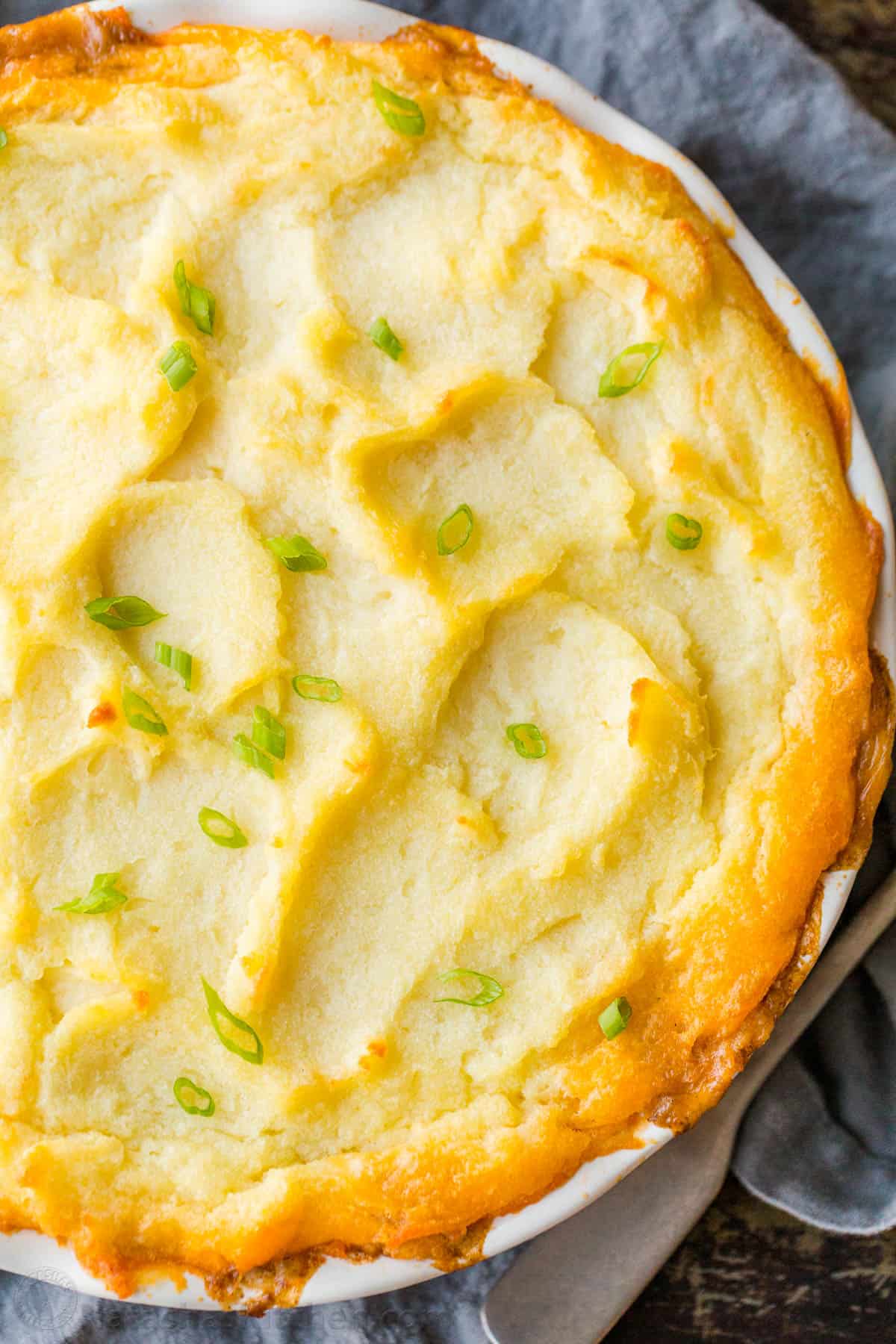 A homey and comforting Shepherd's Pie recipe with a meat and vegetable gravy sauce under a crown of creamy parmesan mashed potatoes. Golden Baked to of Shepherd's Pie