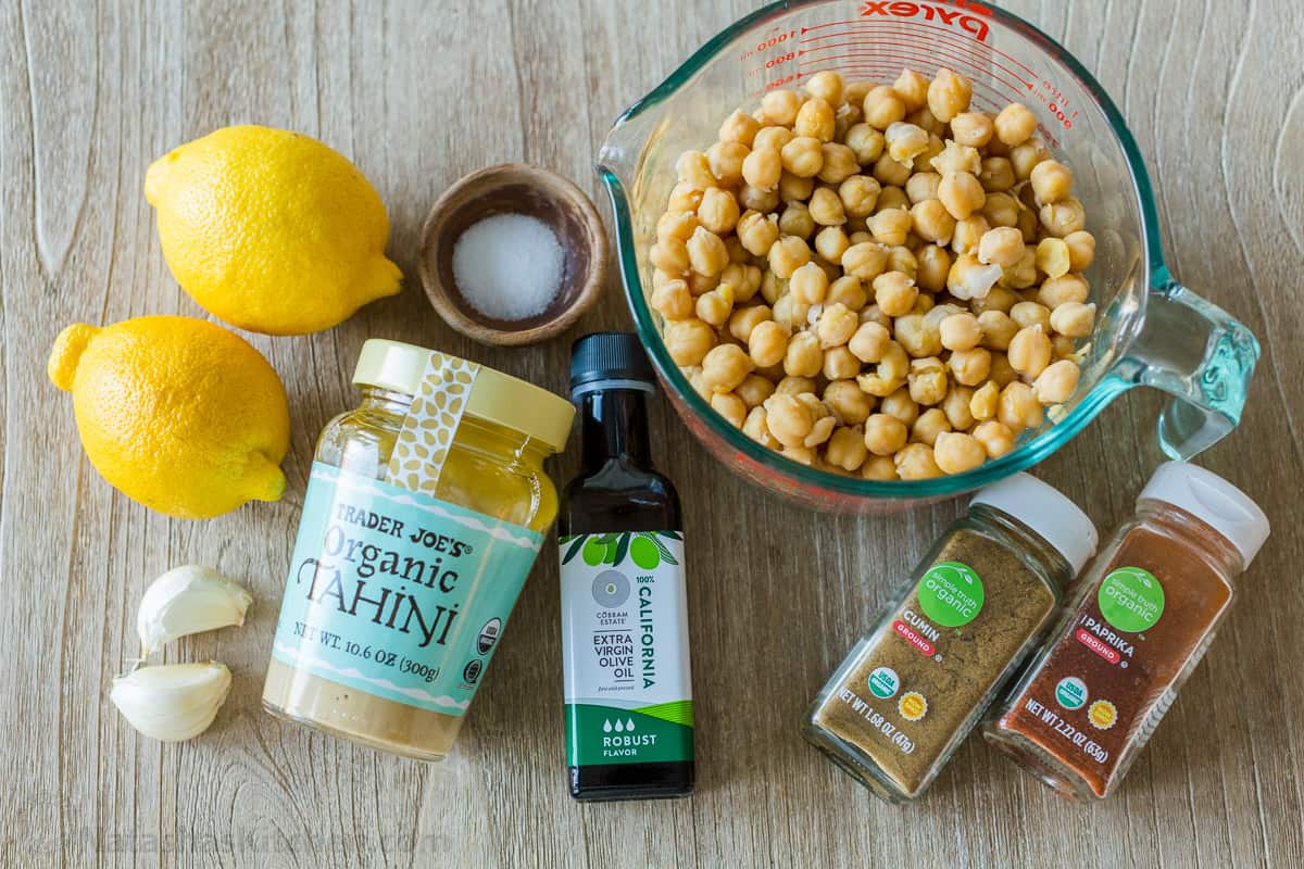 Ingredients for making authentic hummus with chickpeas, tahini, lemons, garlic, and olive oil