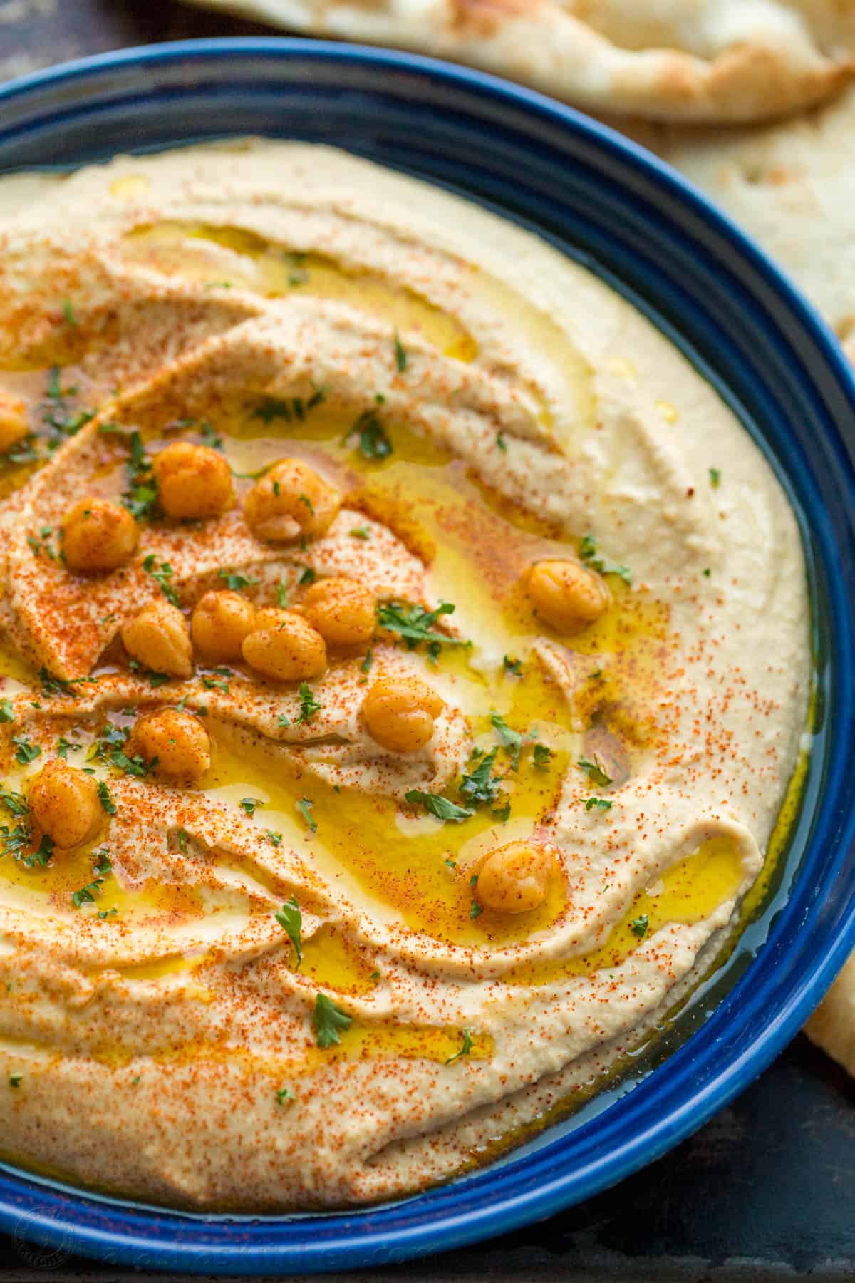 Freshly made hummus garnished with chickpeas, oil and paprika