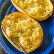 Baked spaghetti squash on a serving platter with fork