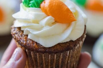 Carrot cake cupcake frosted and decorated with carrot