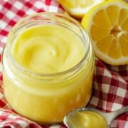 Homemade Lemon curd in a glass jar with spoon