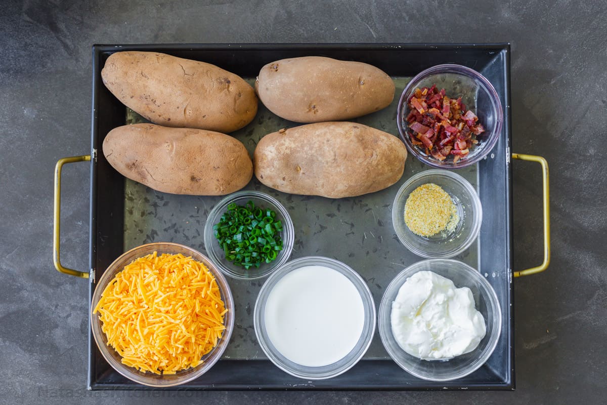 Ingredients for twice-baked potatoes with russet potatoes, cheese, cream, sour cream and bacon