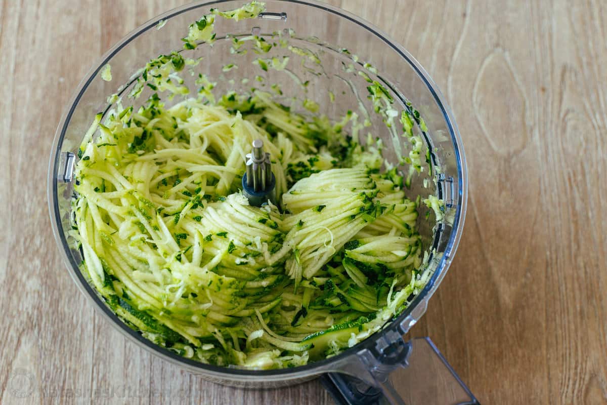 These crispy homemade zucchini fritters are a kid-friendly family favorite. An easy summer zucchini recipe you'll make again and again. Shredded zucchini in food processor