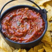 Roasted tomato salsa served in a dish with tortilla chips