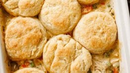 Chicken Pot Pie Casserole served in a baking dish topped with biscuits