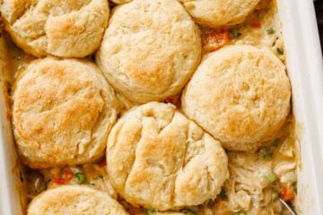 Chicken Pot Pie Casserole served in a baking dish topped with biscuits