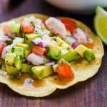 ceviche recipe served on a tostada with lime wedge