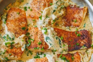 Tuscan salmon in cream sauce served in skillet