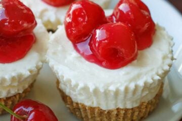 No bake mini cheesecakes with cherry topping on plate