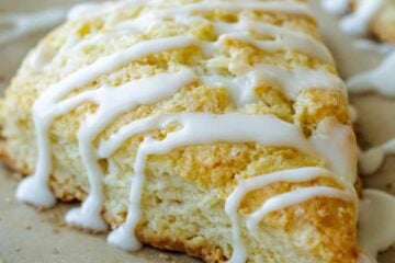 Classic baked scones drizzled with vanilla glaze, cut into wedges