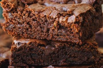 3 zucchini brownie squares stacked displaying the moist, fudgy center