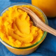 Pumpkin puree in a bowl with wooden spoon