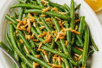 green beans with almonds for thanksgiving in a white dish