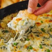 Baked Spinach and Artichoke dip served on a pita chip
