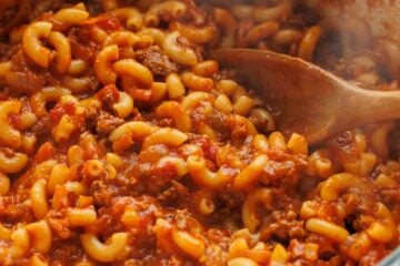 Dutch oven filled with American Chop Suey recipe with ground beef, tomatoes and elbow macaroni pasta