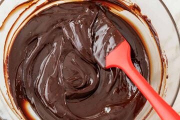 Chocolate ganache mixed in a glass bowl