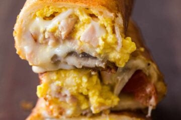 Stack of cheesy breakfast burritos
