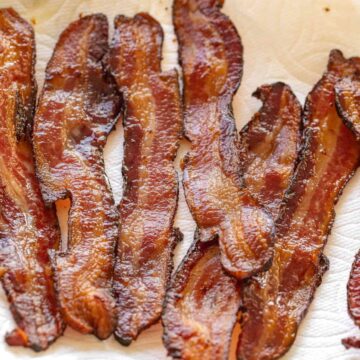crispy oven-baked bacon on a plate lined with paper towel