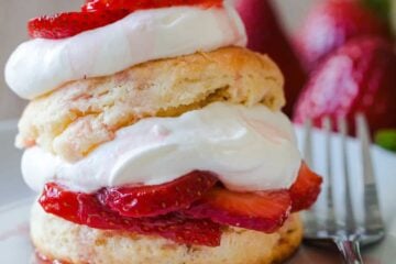 classic strawberry shortcake recipe using homemade biscuits, strawberries in sugar and whipped cream
