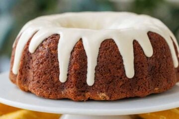 Glazed Banana Bundt Cake with a yellow table cloth and knife for cutting