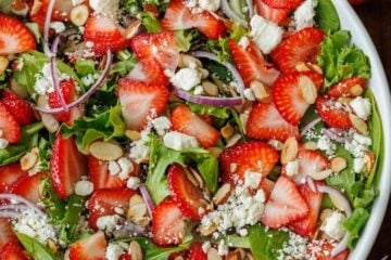 strawberry salad with honey vinaigrette in a white bowl