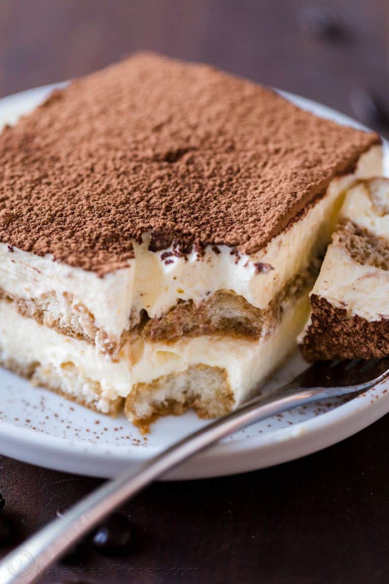 Tiramisu cake slice on a plate with a fork