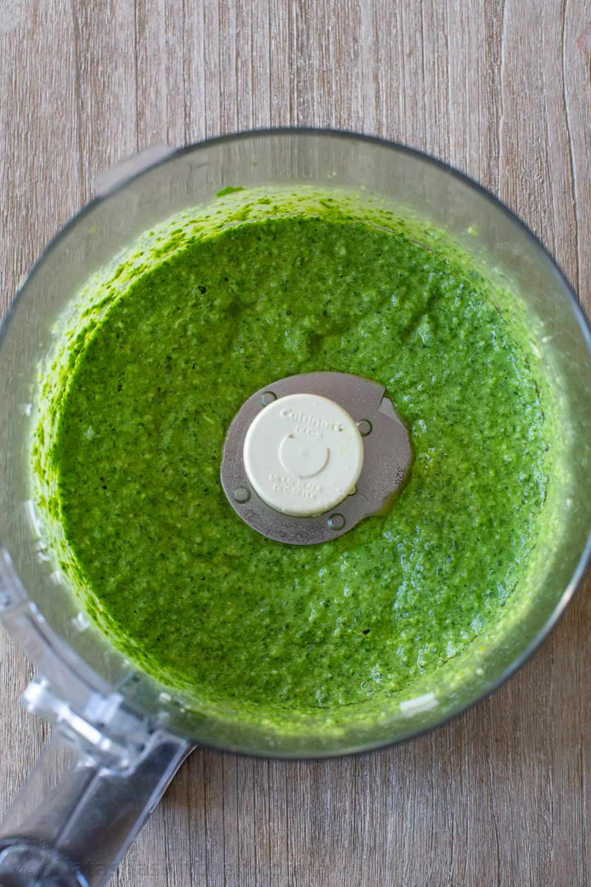 Blended pesto sauce in a food processor bowl