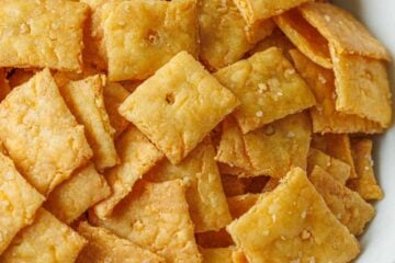 Sourdough cheese crackers, discard recipe, baked and lightly salted, served in a white bowl