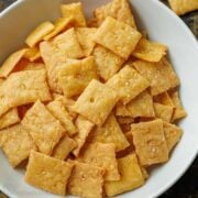 Sourdough cheese crackers, discard recipe, baked and lightly salted, served in a white bowl