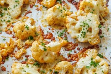 Roasted parmesan cauliflower florets with parsley and crispy, cheesy bits
