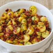 German Potato Salad, Warm, tender potatoes with crispy bacon and fresh herbs tossed in a tangy mustard dressing.