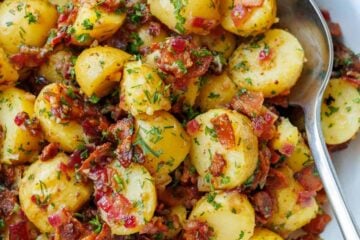 German Potato Salad with bacon bits and parsley tossed in a dijon mustard and vinegar dressing