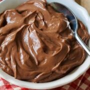 Viral hard boiled egg chocolate pudding in a white dish with a spoon and red plaid napkin