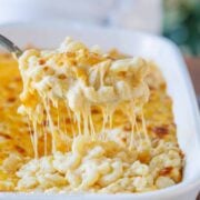 Baked mac and cheese served with a spoon from casserole dish