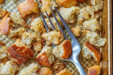 Sourdough Croutons on a baking sheet with a fork.