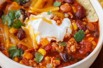 Bowl of the best turkey chili recipe with tortilla chips on the side