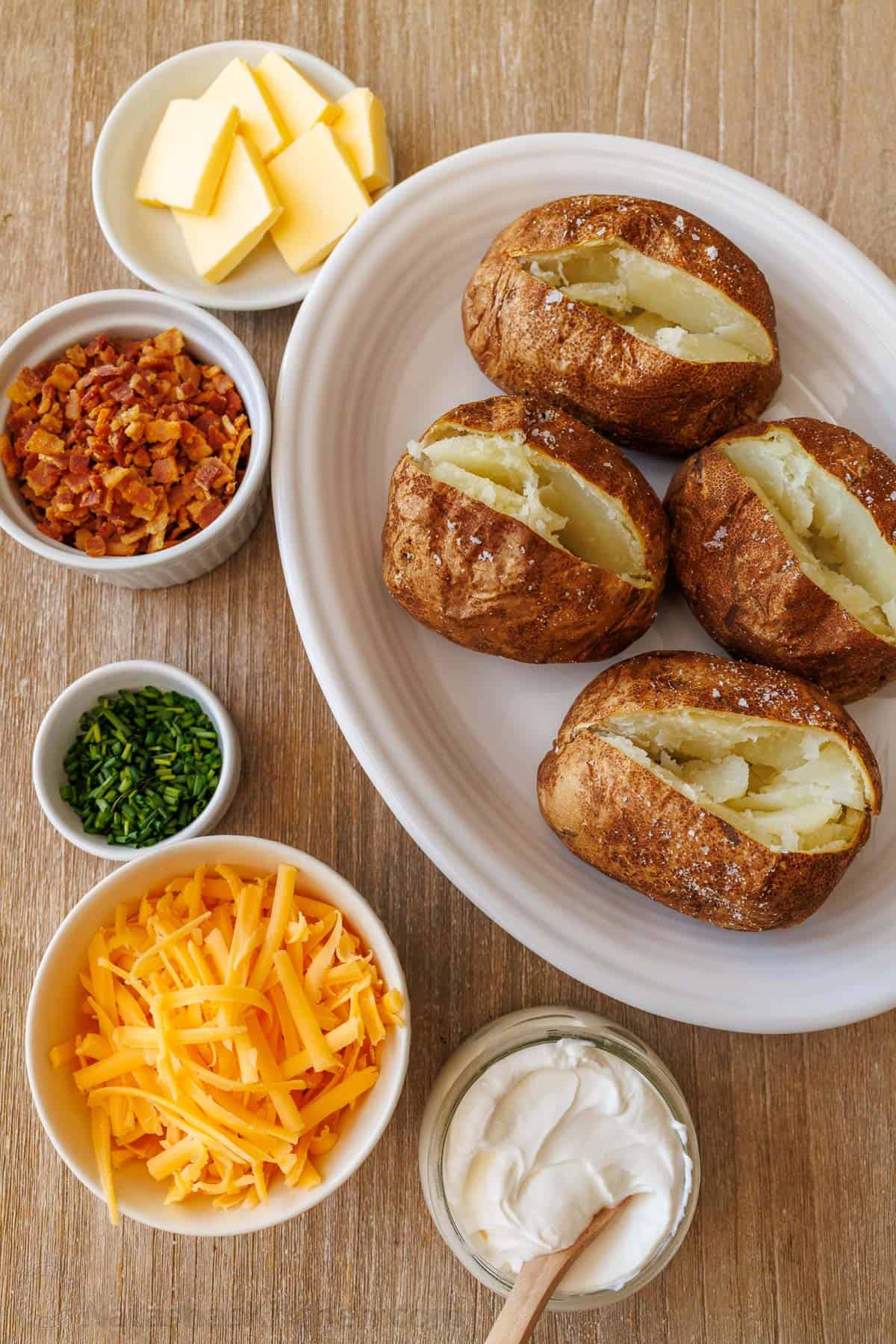 Baked potato bar with air fryer baked potatoes and toppings in bowls